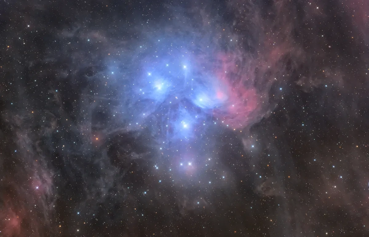 A very bright blue star cluster in a starry sky.